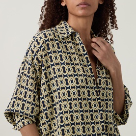 Model wearing Away That Day cover up in Navy/Gold Link Print, relaxed fit with open collar and elbow-length sleeves, 100% viscose.