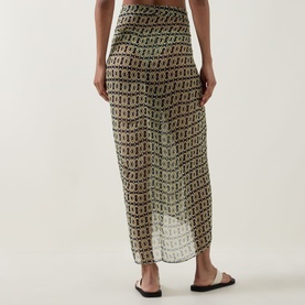 Model wearing Away That Day Navy/Gold Link Print Sarong, styled with black flat sandals. Semi-sheer viscose midi length with all-over chain link