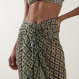 Model wearing Away That Day Navy/Gold Link Print Sarong, knotted at hip, styled with matching printed crop top
