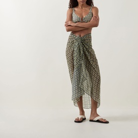 Model wearing Away That Day Navy/Gold Link Print Sarong tied at hip, styled with matching bikini top and sandals