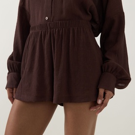 Model wearing Away That Day brown cover-up shorts with elasticated waist and relaxed fit, styled with matching long-sleeve top.