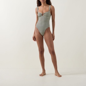 Model wearing Away That Day swimsuit in Navy/Gold Link Print, featuring a sweetheart neckline and high-cut leg silhouette