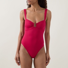 Model wearing Away That Day raspberry swimsuit with sweetheart neckline, cut-out detail, ruched bust and wide straps.