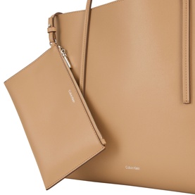 Calvin Klein tannin tote bag with detachable wristlet pouch, smooth faux leather finish, gold-tone hardware, close-up detail view