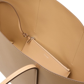 Calvin Klein tannin tote bag interior view showing beige lining, zip pouch insert, and silver-tone zip detail