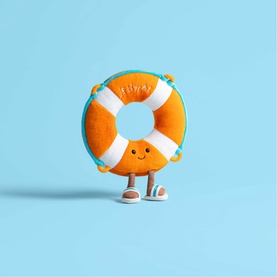 Jellycat orange lifebuoy ring plush toy with white stripes, smiley face, and small feet, on a light blue background