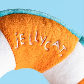 Jellycat plush life ring toy in orange, white and teal with embroidered Jellycat logo, close-up detail shot