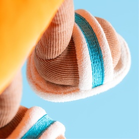 Jellycat plush soft toy in peach and teal stripe corduroy texture, close-up detail shot showing layered coiled sections
