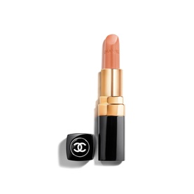 Chanel Rouge Coco lipstick in peachy-nude shade, black and gold bullet tube with cap placed beside it