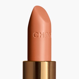 Chanel Rouge Coco lipstick in nude-peach shade with embossed branding, shown in gold bullet casing without cap