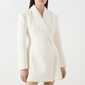Model wearing Odd Muse cream blazer dress with structured shoulders, double-breasted front and flared skirt silhouette