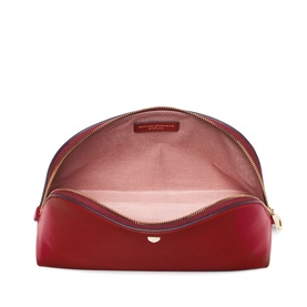 Aspinal of London Cherry Red leather cosmetic case open to reveal pink suede interior with gold zip hardware