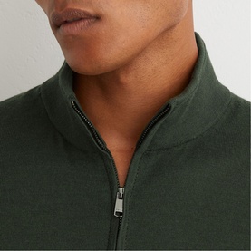 Model wearing Reiss dark green half-zip knit jumper, close-up of zip collar detail