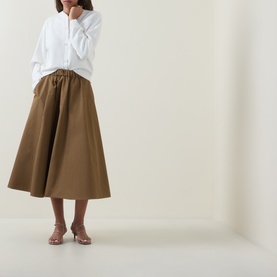 Model wearing Ted Baker Neslie Ivory cardigan, styled with a khaki midi skirt and nude mule heels.