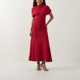 Model wearing Ted Baker Maevely Asymmetric Flared Dress in red, with asymmetric neckline, ruched sleeves and flared maxi skirt, styled with black
