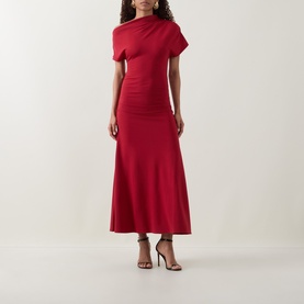 Model wearing Ted Baker Maevely Asymmetric Flared Dress in red, asymmetric neckline, ruched sleeves, maxi length, styled with strappy heels