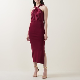 Model wearing Ted Baker Mellana Twist-Detail Dress in Burnt Red with halter neckline, satin bodice, midi length and side split, styled with gold