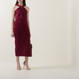 Model wearing Ted Baker Mellana Twist-Detail Dress in Burnt Red, halterneck satin midi with twist detail, styled with nude heeled sandals.