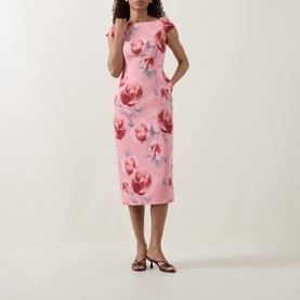 Model wearing Ted Baker Odeta Floral Fitted Dress in coral, featuring boat neckline, cap sleeves and large floral print midi length silhouette.
