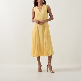 Model wearing Ted Baker Rueva Flared Dress in yellow, sleeveless V-neck midi with pleated flared skirt, styled with gold strappy heels