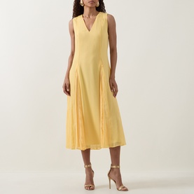 Model wearing Ted Baker Rueva Flared Dress in yellow, sleeveless V-neck midi with front pleats and flared skirt, styled with nude heeled sandals.