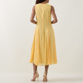 Model wearing Ted Baker Rueva Flared Dress in yellow, sleeveless midi length with flared skirt, shown from behind. Styled with gold heeled sandals.