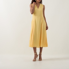 Model wearing Ted Baker Rueva Flared Dress in yellow, featuring V-neckline, sleeveless cut and pleated midi skirt, styled with nude heels.