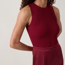 Model wearing Ted Baker Izeny Placement Floral Jumpsuit in dark red, showing sleeveless ribbed bodice with round neckline and fitted waist detail.