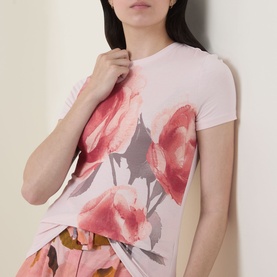 Model wearing Ted Baker Bindii Placement Floral T-Shirt in coral with large watercolour floral print, crew neck, short sleeves