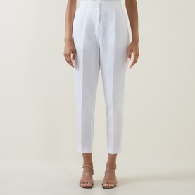 Model wearing Ted Baker Musubt Cropped Straight Leg Trousers in white with front creases, styled with nude heeled sandals.