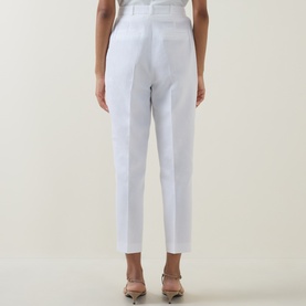 Model wearing Ted Baker Musubt Cropped Straight Leg Trousers in white, rear view, styled with nude heeled mules.