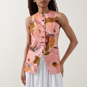 Model wearing Ted Baker Narlla Floral Print Waistcoat in coral with button front and curved hem, styled with a white maxi skirt.