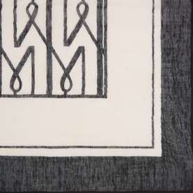 Masai black scarf with geometric monogram border pattern, cream centre panel, in modal cotton linen blend