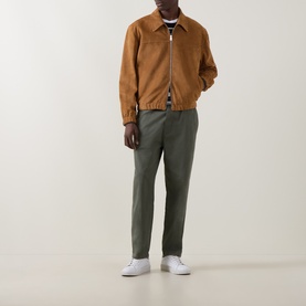 Model wearing Paul Smith brown suede casual jacket with zip fastening, styled with olive trousers and white trainers.