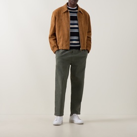 Model wearing Paul Smith brown suede casual jacket, styled with navy stripe knit, olive trousers and white trainers.