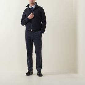 Model wearing Paul Smith blue casual jacket, styled with grey trousers, white shirt and navy tie. Zip-front with hood.
