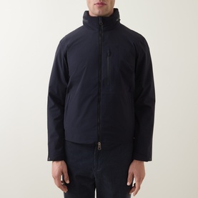 Model wearing Paul Smith blue casual jacket with high collar, zip fastening and chest zip pocket.