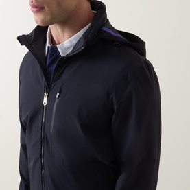 Model wearing Paul Smith blue casual jacket with zip-through hood, silver zip detail and navy knit layer visible beneath.