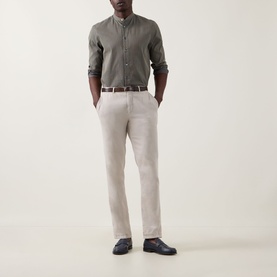 Model wearing Paul Smith blue cotton-silk casual shirt with stone linen trousers, brown belt and navy leather shoes
