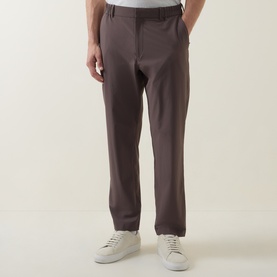 Model wearing Paul Smith Grey Casual Trousers with slim straight fit, styled with white low-top trainers