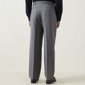 Model wearing Paul Smith Double Pleat Wool Trousers in grey, rear view, styled with dark navy shirt and black leather shoes.