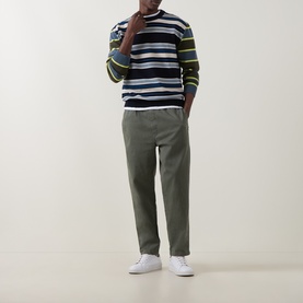 Model wearing Paul Smith blue striped lambswool crew neck jumper with khaki trousers and white trainers.