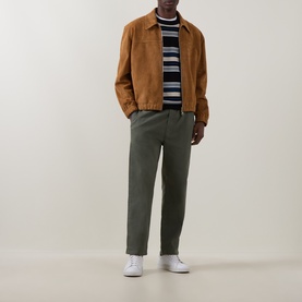 Model wearing Paul Smith Blue Striped Crew Neck Jumper with tan suede jacket, olive trousers and white trainers.