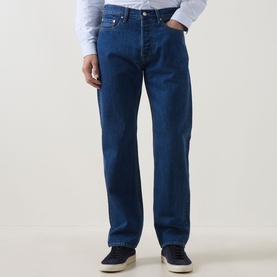 Model wearing Paul Smith blue straight-leg cotton jeans, styled with a white shirt and navy trainers.