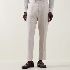 Model wearing Paul Smith white linen-wool formal trousers, styled with a white shirt and dark burgundy leather loafers.