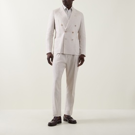 Model wearing Paul Smith white linen-wool formal trousers, styled with matching double-breasted blazer, white shirt, and dark brown loafers.
