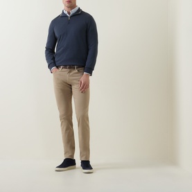 Model wearing Paul Smith Mid Blue Half-Zip Regular-Fit Sweater with beige chinos and navy trainers.