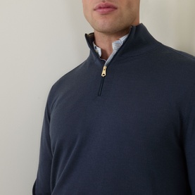 Model wearing Paul Smith Half-Zip Regular-Fit Sweater in mid blue, fine knit with gold zip, styled with a striped shirt collar visible underneath.