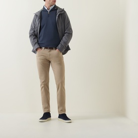 Model wearing Paul Smith Mid Blue Half-Zip Regular-Fit Sweater, styled with a grey hooded jacket, white shirt, and beige chinos.
