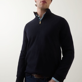 Model wearing Paul Smith Half-Zip Regular-Fit Sweater in navy merino wool with gold zip detail, styled over a blue patterned shirt.